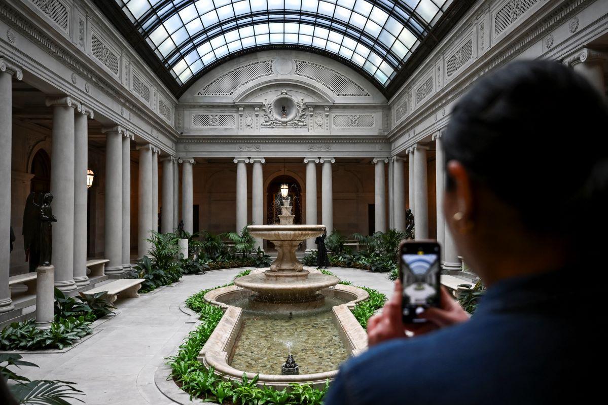 A person takes a picture of the Garden Court at The Frick Collection press preview on March 25.