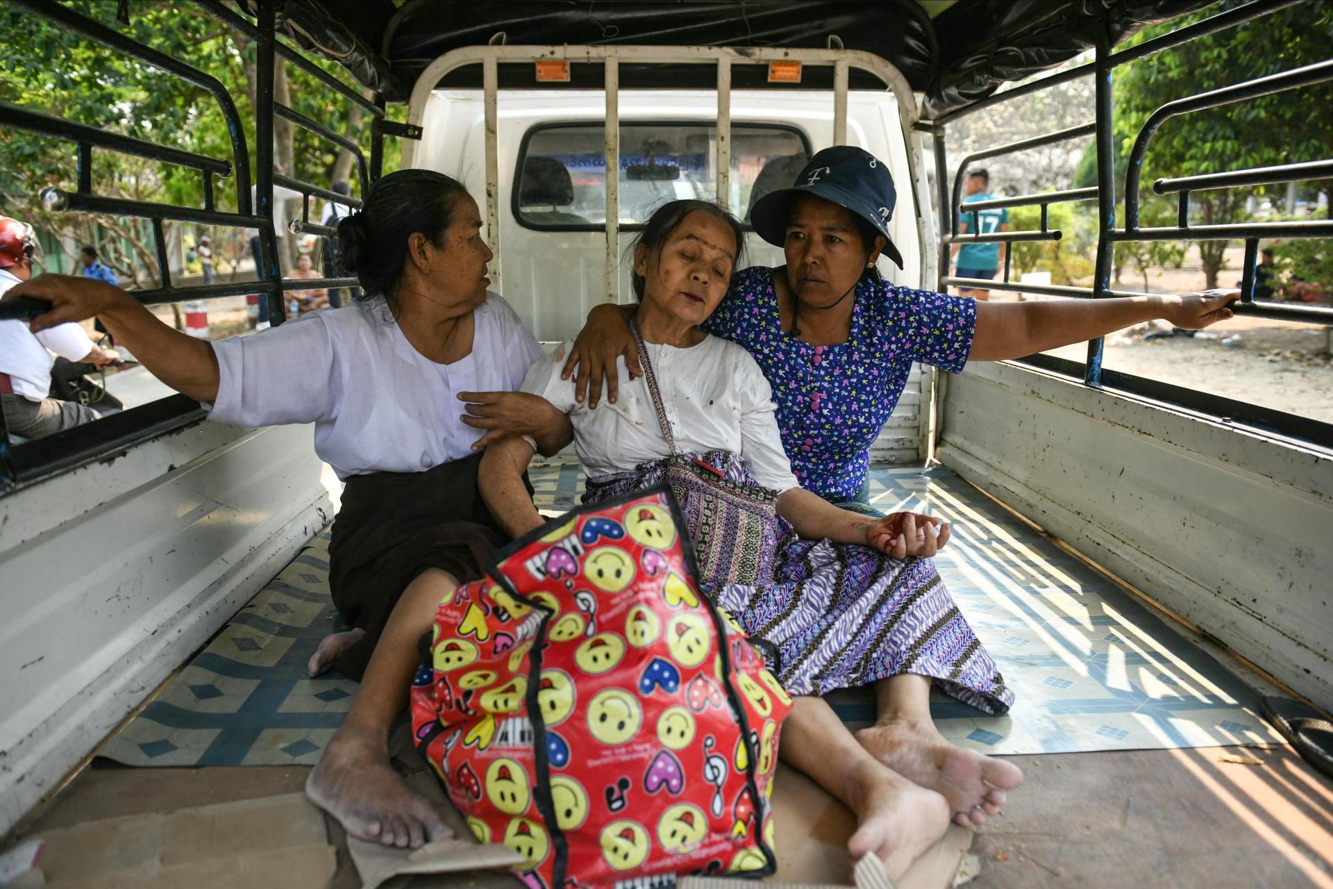 A survivor reacts as she is brought in the back of a lorry to a hospital in Naypyidaw. Photo: AFP