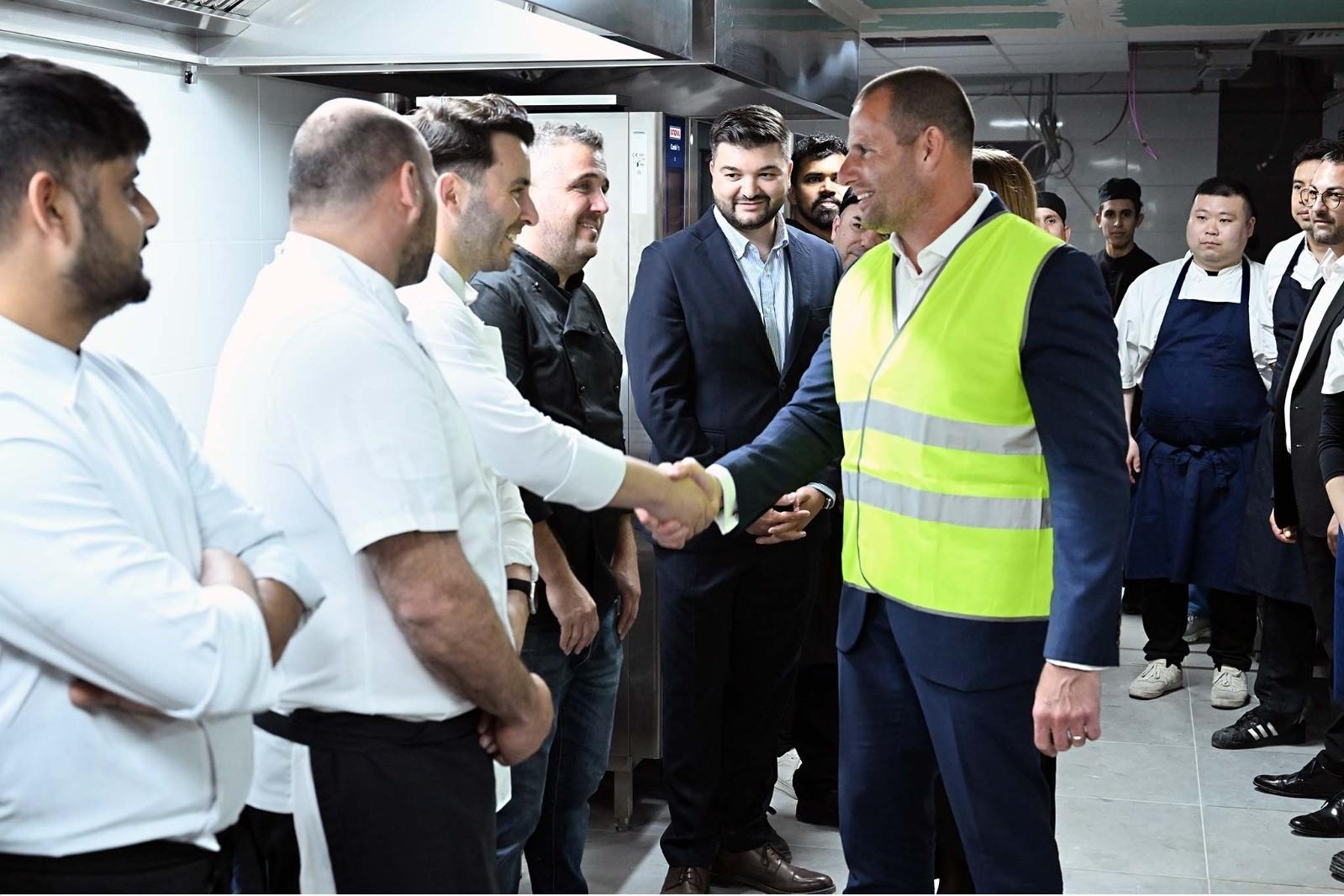 The prime minister meets workers during his visit.