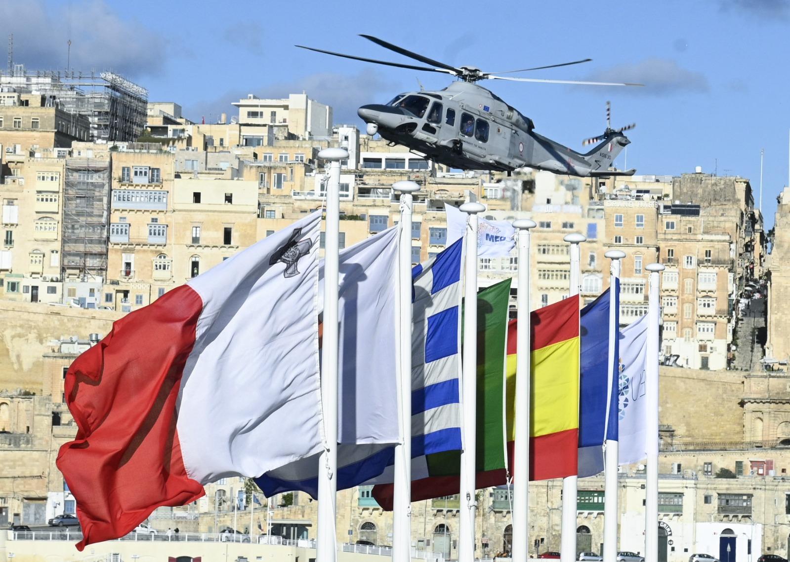A helicopter carrying a MED5 flag flew-by to greet the ministers. Photo: Matthew Mirabelli