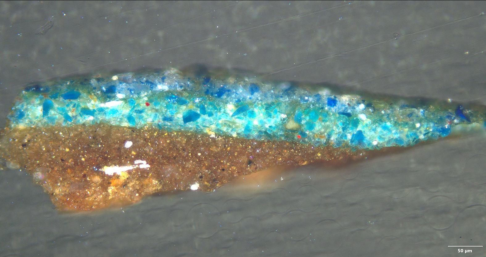 A fragment being examined under the microscope showing the various layers making up the Virgin&rsquo;s blue draping.