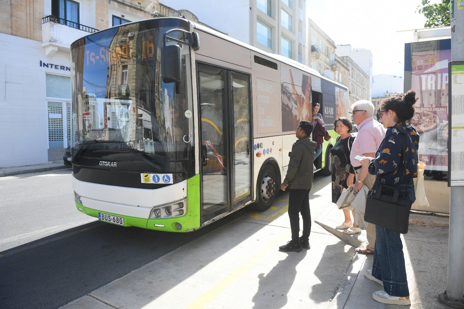 Giulia queueing to board the bus.