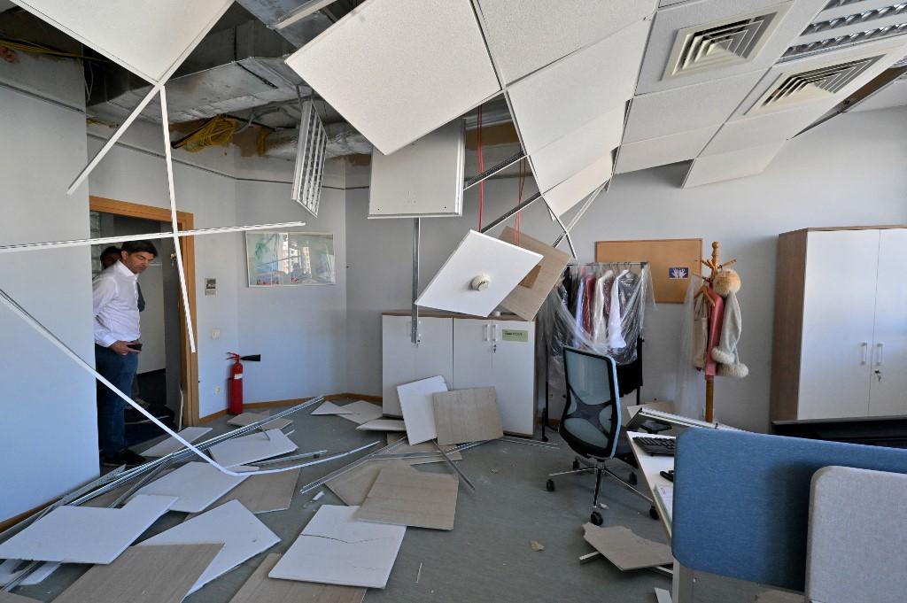 A EU employee watch damages in the offices of the European Union delegation in Ukraine. Photo: AFP