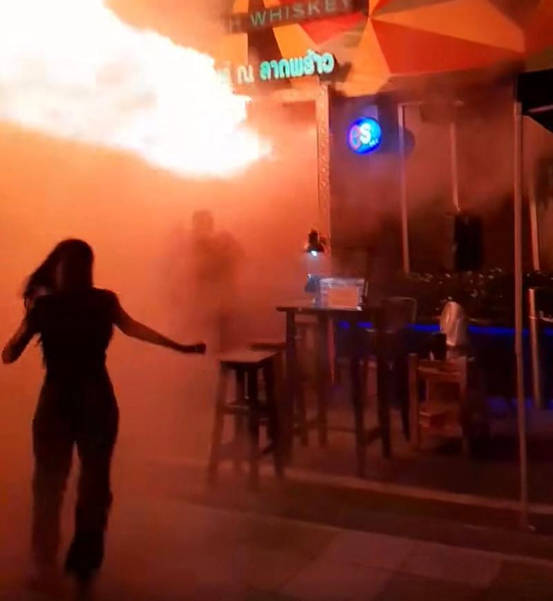This screen grab taken from a video released by Kan Kutirat on July 12, 2026 shows people fleeing a fire at the Rong Beer Na Lat Phrao bar in Bangkok.