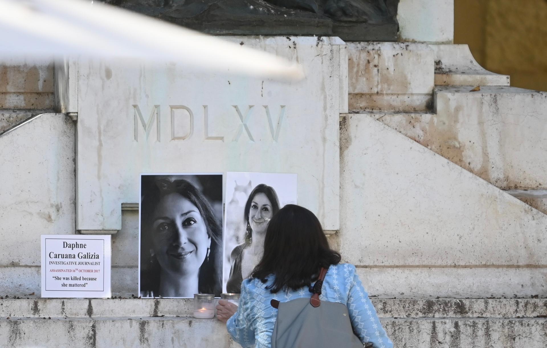 Daphne Caruana Galizia's sister pauses at the makeshift memorial before entering court last week. Photo: Jonathan Borg