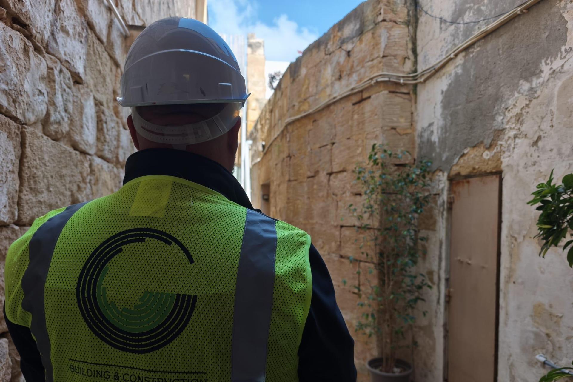 A BCA officer inspects the site on St Vincent Alley in a visit to the collapsed building. Photo: BCA.