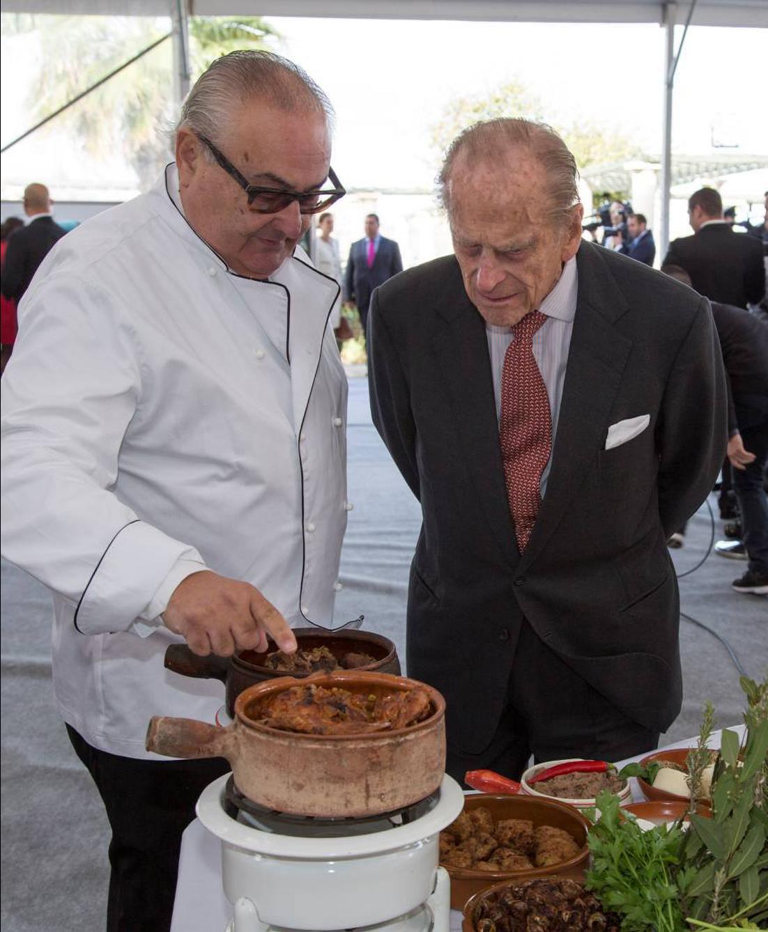 Dougall showing the late Prince Philip his table of traditional Maltese food. Photo: Facebook/Anton B. Dougall