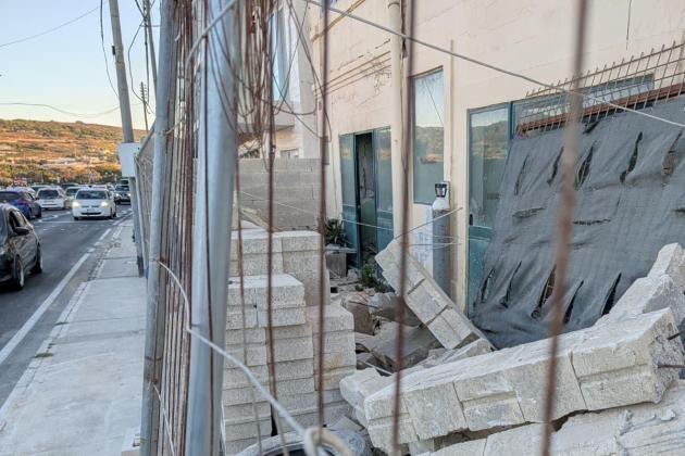 Wall collapses onto pavement after being hit by light truck