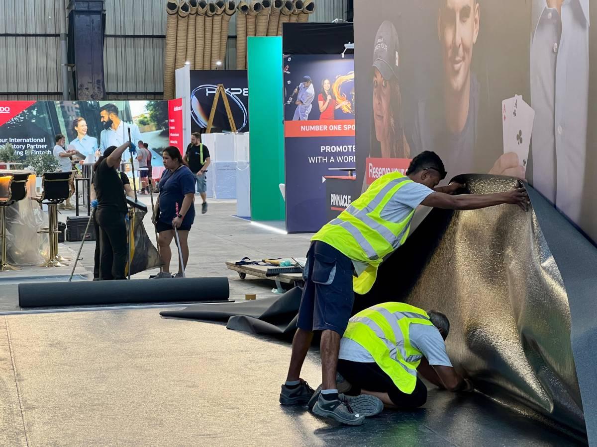 Workers busy putting the finishing touches to a stand. Photo: Chris Sant Fournier.