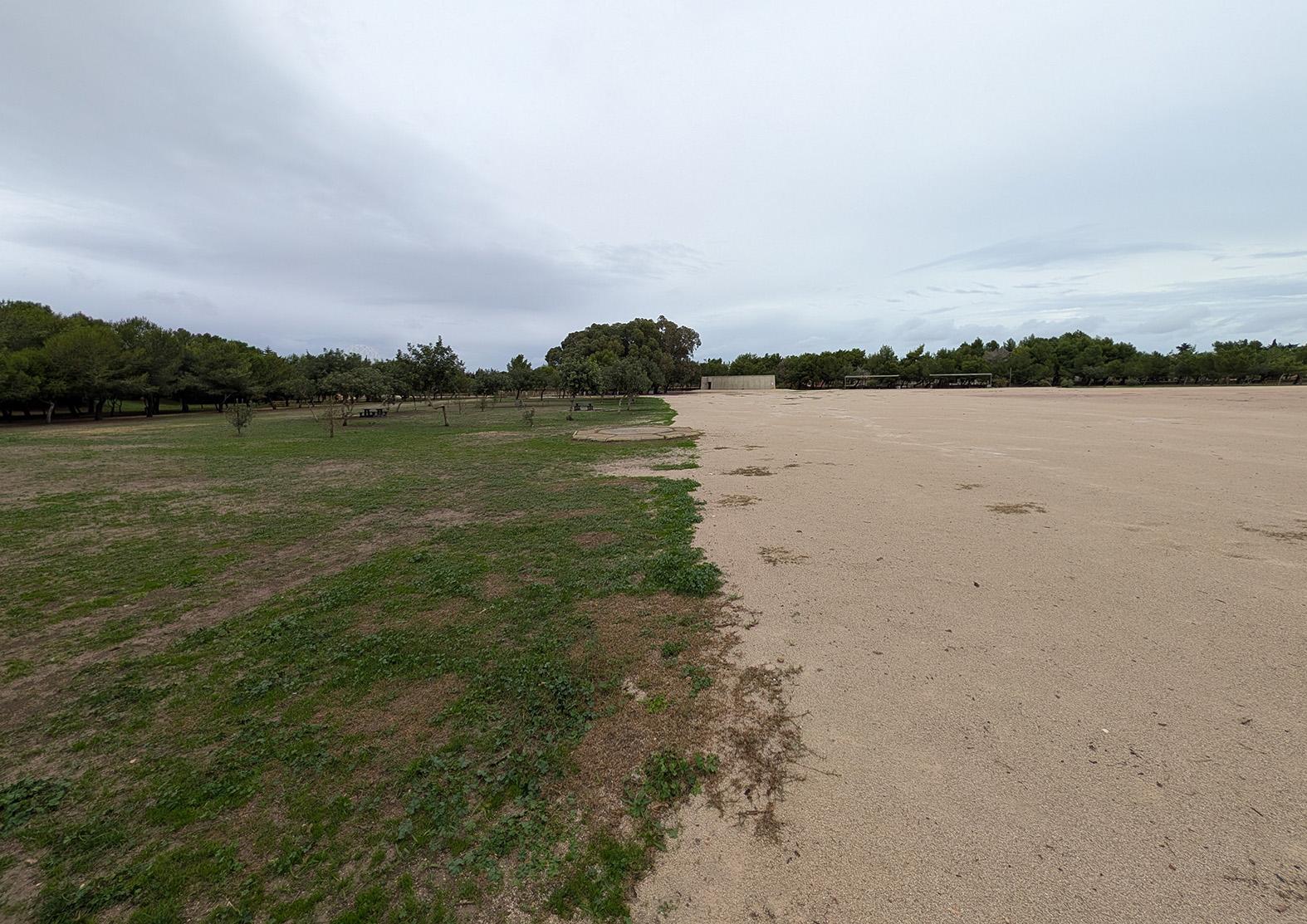 Despite assurances the grass would grow back, the area with gravel remains conspicuously lifeless.