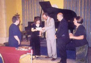 British High Commissioner Vincent Fean presenting Valerie Anne Fenech, who placed first, with her prize. Looking on are Mgr Fortunato Mizzi and NCW president Grace Attard.