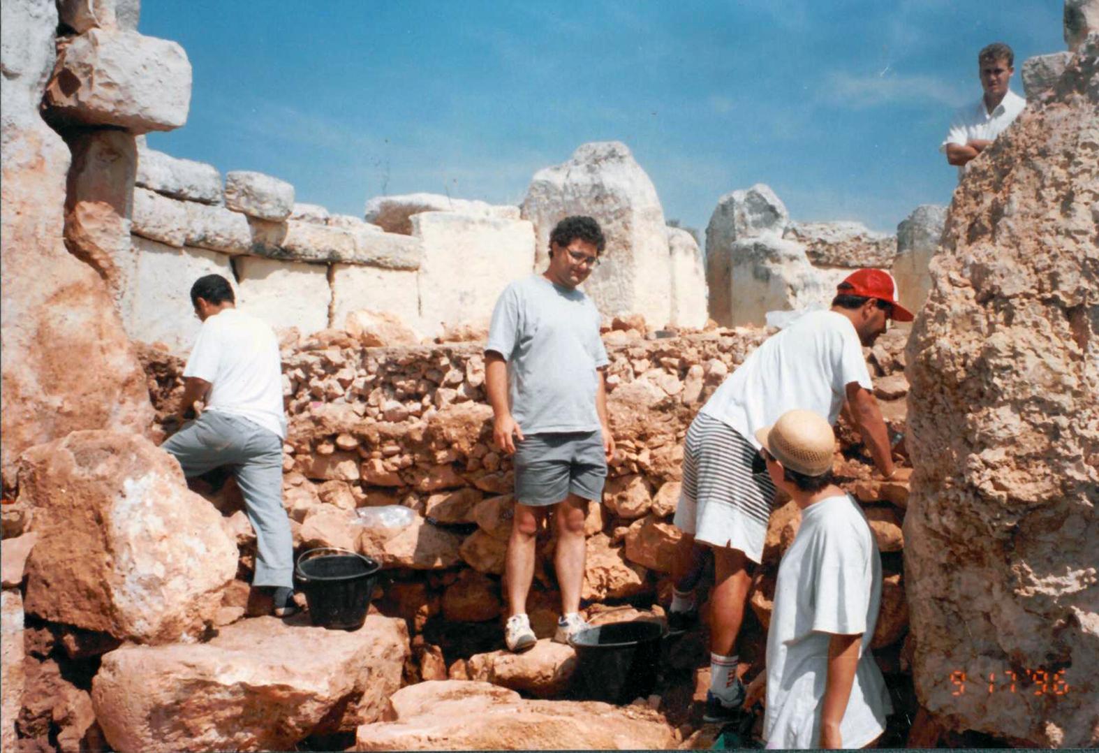 Mario Coleiro (in red cap) working on restoring the megalith after a storm.