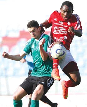 Victoria Hotspurs&rsquo; Didier Tayou (right) leaps to beat Sannat&rsquo;s Nicholas Micallef to the ball. Photo: Joseph Mercieca