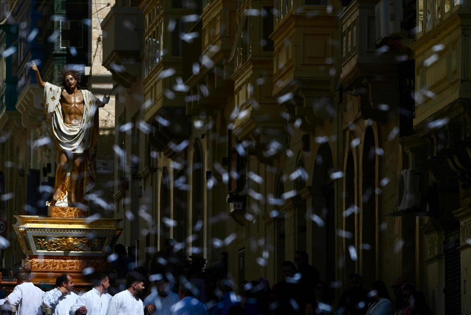 Confetti flying through the streets as the statue of the Risen Christ makes its way. Photo: Jonathan Borg