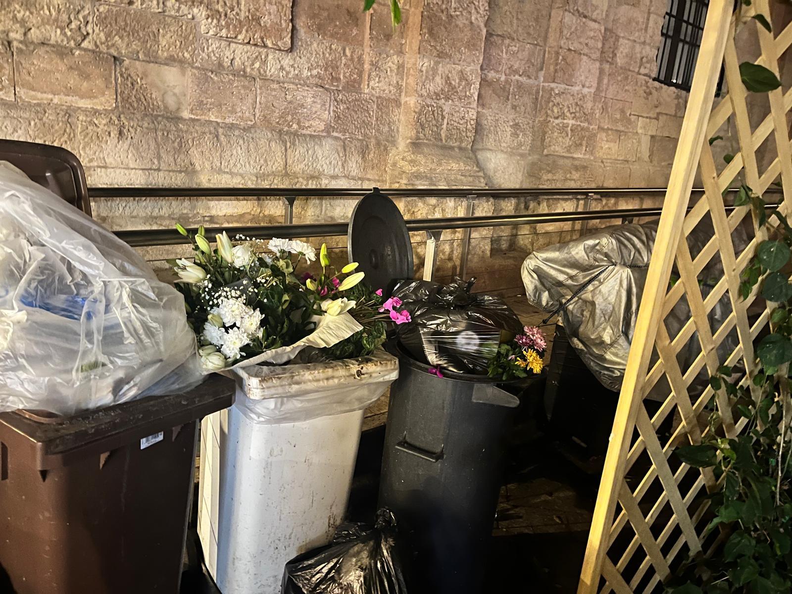 The flowers and other tributes ended up in near dustbins.