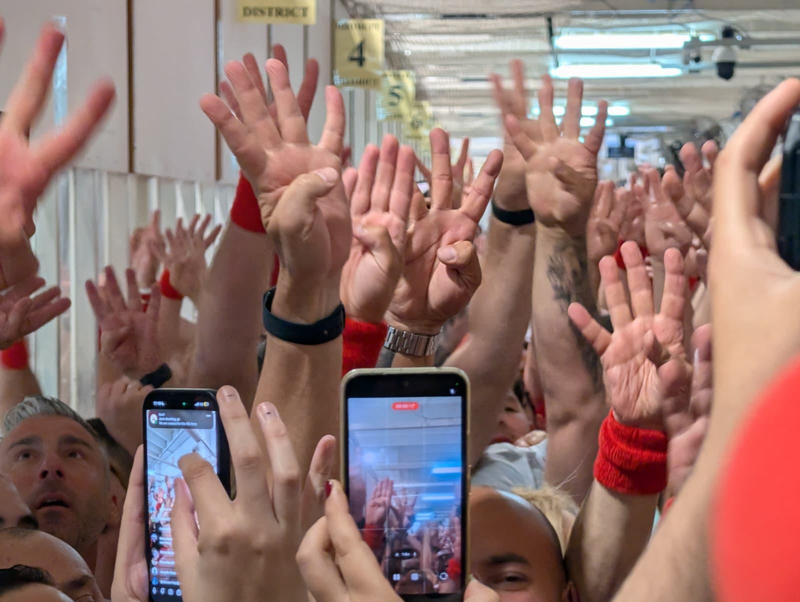 Labour Party members at the Naxxar counting complex hold up four fingers signalling the fourth successive victory. Photo: Chris Sant Fournier