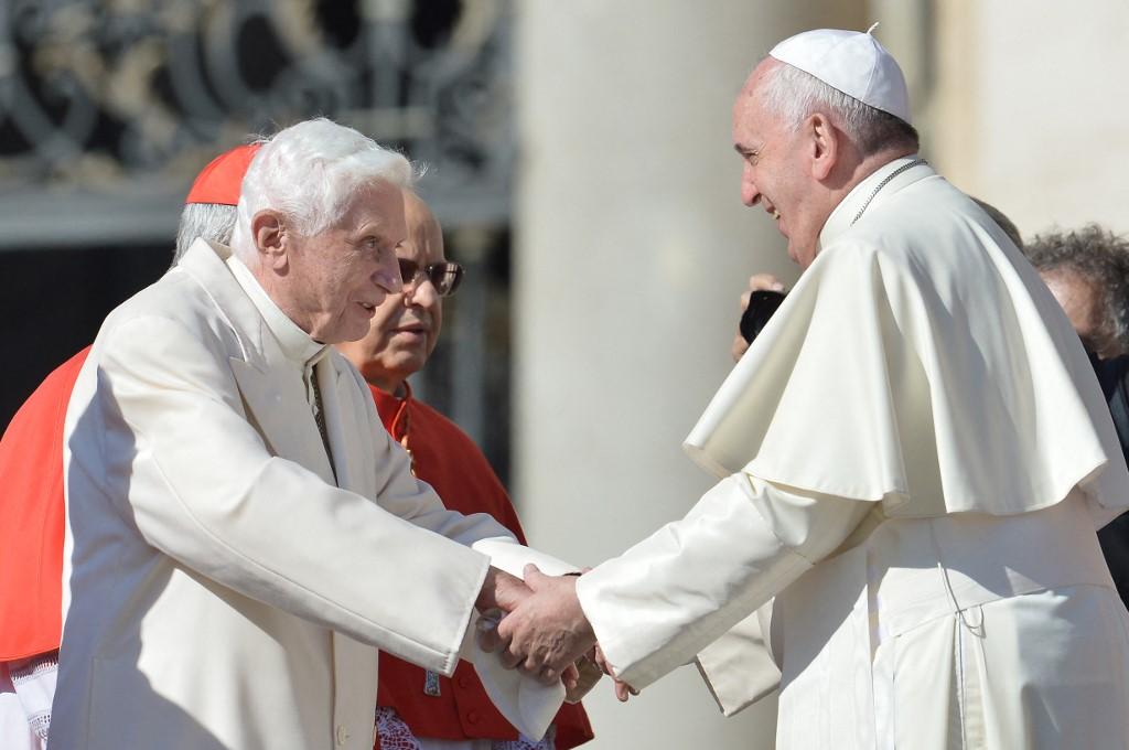 Pope emeritus Benedict XVI (L) speaks with Pope Francis during a papal mass for elderly people at St Peter's square at the Vatican on September 28, 2014. Photo: AFP