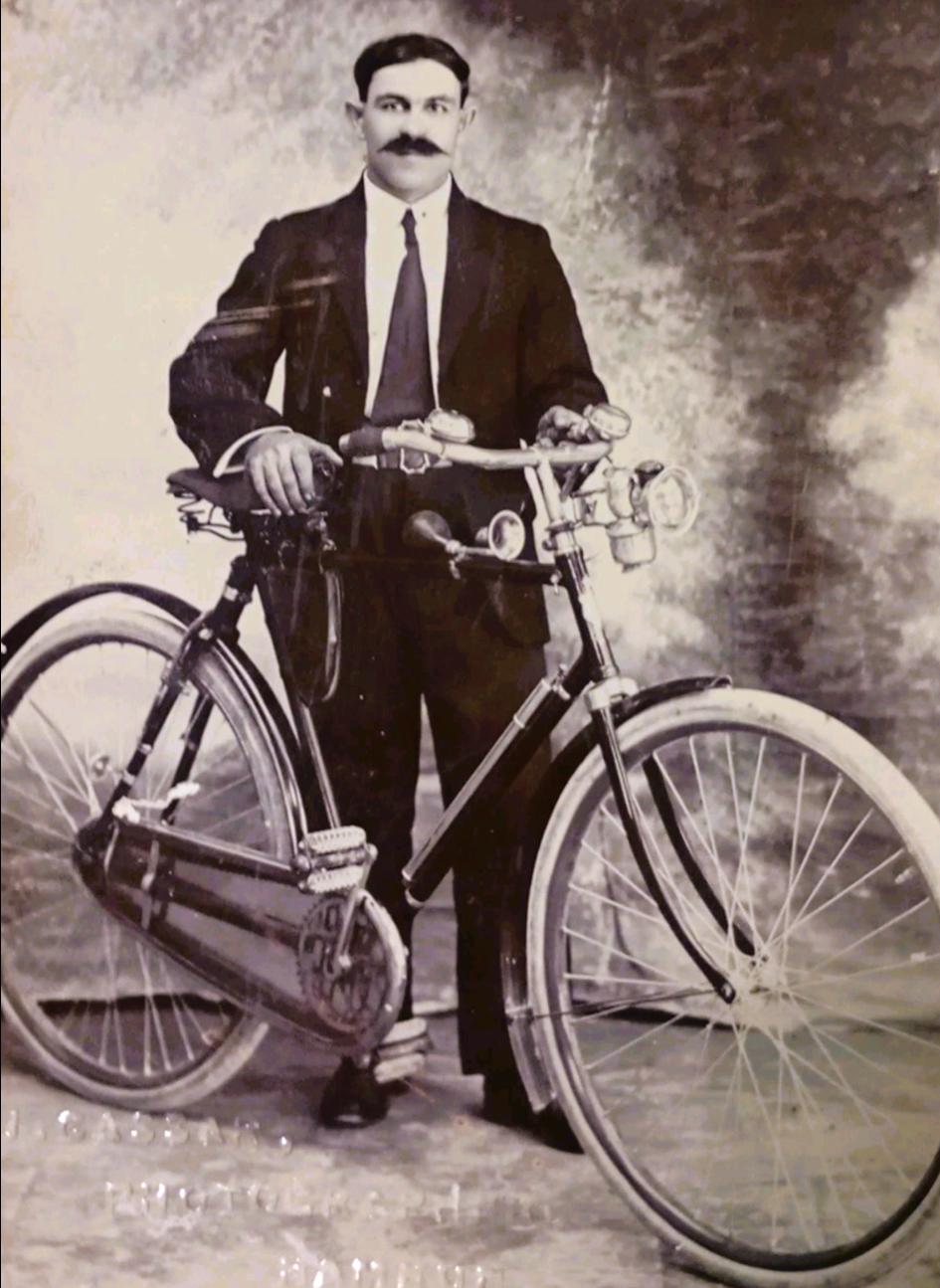 A Joseph Cassar portrait of a man with a bicycle, 1930s.