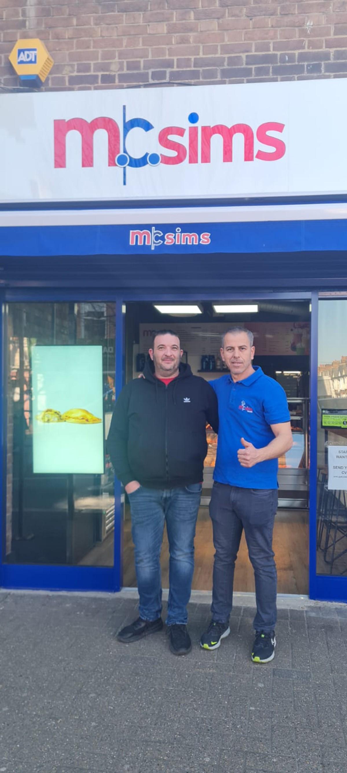 Fabrizio and Adel in front of the shop.