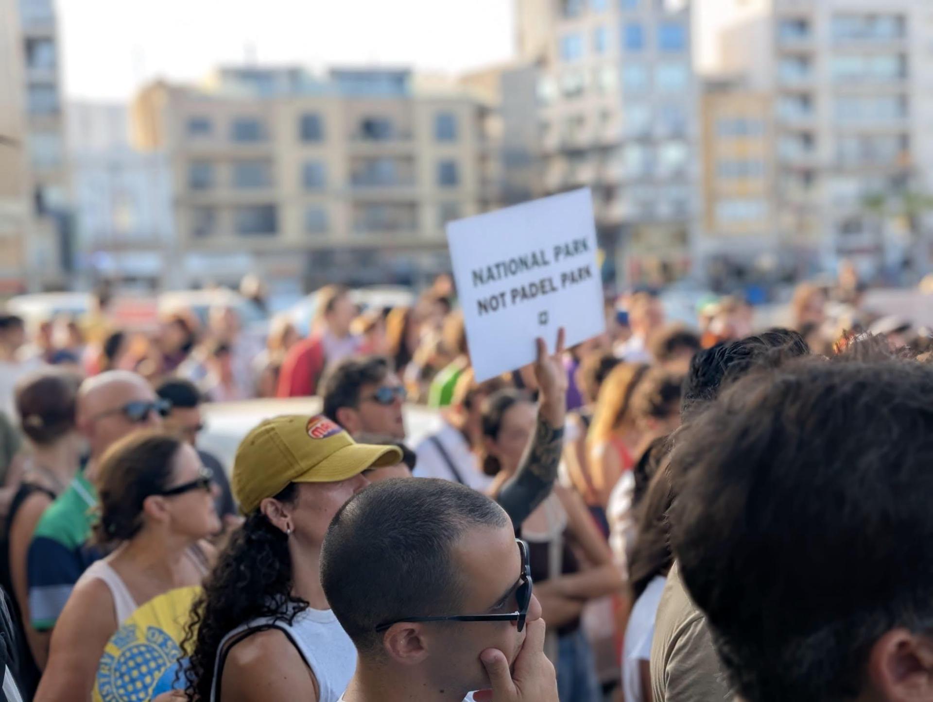 A protester holds aloft a sign calling for "National Park not Padel Park" during Friday's event. Photo: Moviment Graffitti