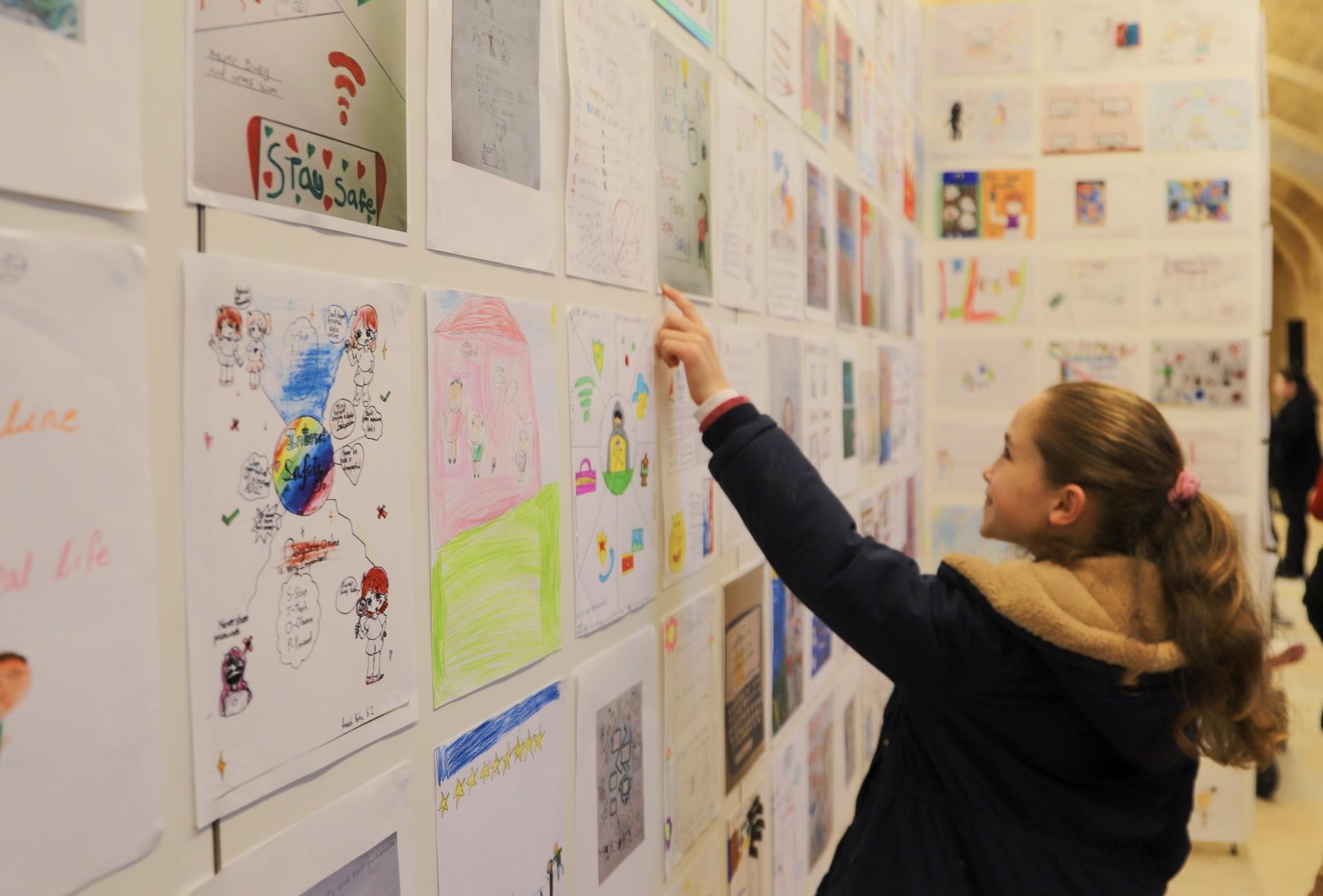 A young student viewing the artworks on display at MICAS, in Floriana.