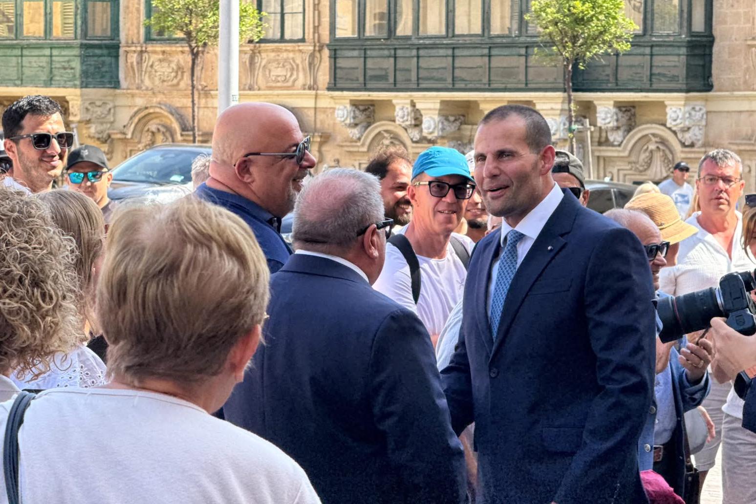 Prime Minister Robert Abela greets people outside the ceremony. Photo: Kristina Vella