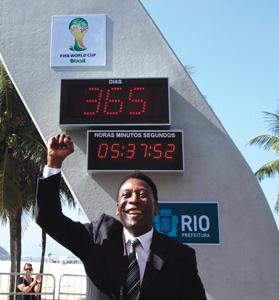 Brazilian icon Pele gestures in front of the countdown clock during an event marking one year to the kick-off of the 2014 FIFA World Cup at Copacabana beach.