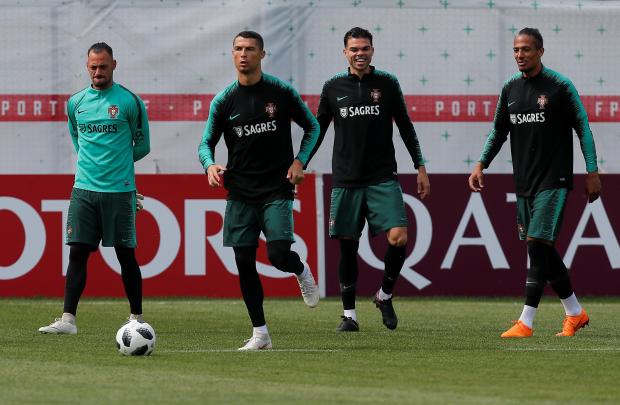 Bruno Alves, Pepe and Cristiano Ronaldo attend a training session.