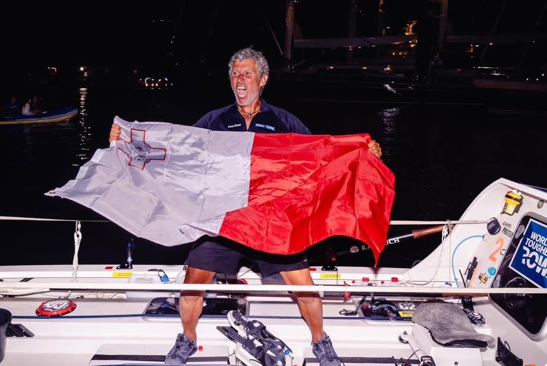 Chetcuti celebrates with the Maltese flag upon his arrival. Photo:Instagram/@worlds.toughest.row