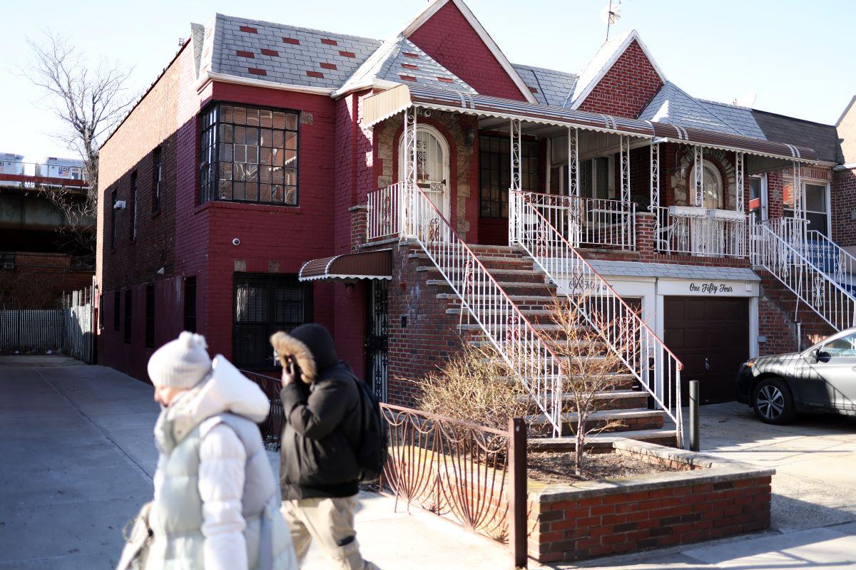 Pedestrians walk past the house at 156 Brighton 11th, the house of the main character of the movie <em>Anora</em>, in the Brighton Beach neighbourhood of New York.