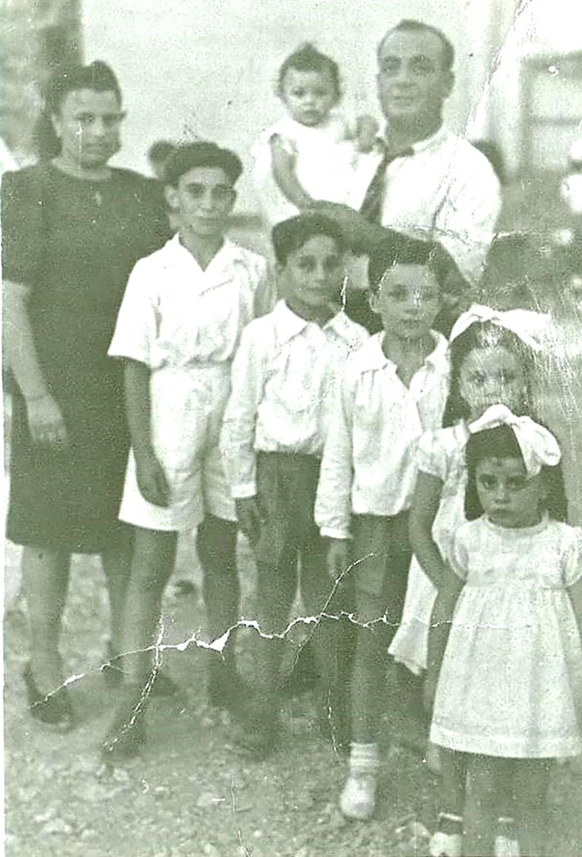 The Caruana family, about 1945, (from left, front row) Lorenza, Francis, Joseph, Emanuel, Mary and Carmela, with Michael holding baby Edith.