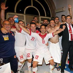 National team players and officials in party mood at the Yerevan stadium dressing room. Photo: Paul Zammit Cutajar