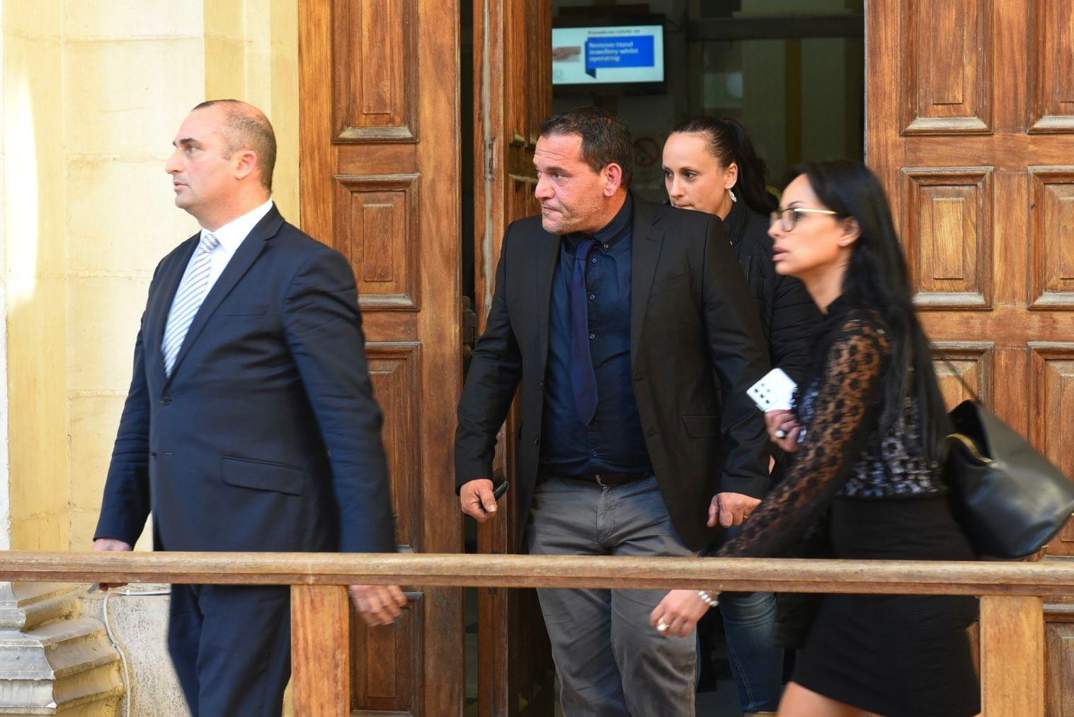 Defence lawyers Franco Debono (left) and Marion Camilleri (right) walk out of Thursday's sitting with the accused's brother (centre). Photo: Chris Sant Fournier.