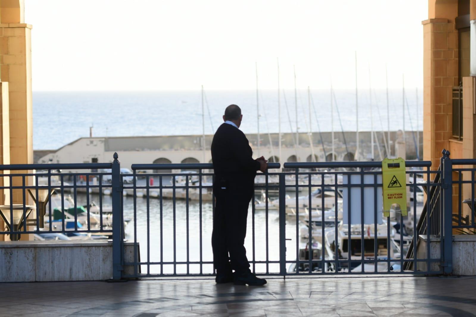 A police officer stands guard outside Portomaso on Wednesday morning. Photo: Jonathan Borg