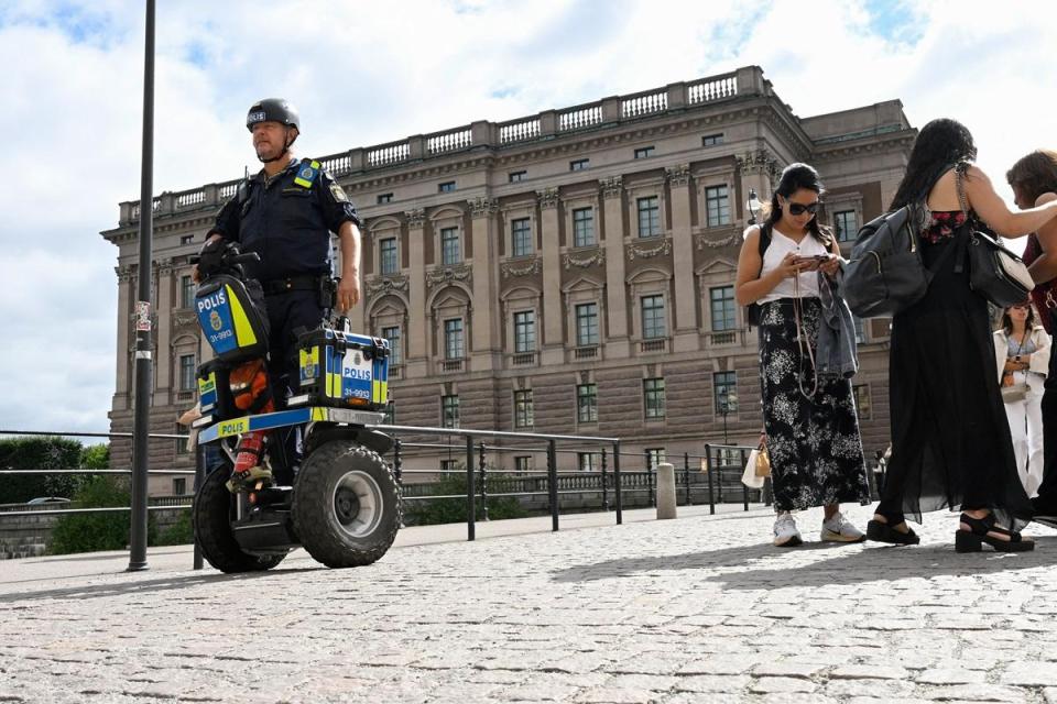 A police officer on a Segway patrols at Sweden's parliament Riksdagen as the terror threat level in Sweden was raised.