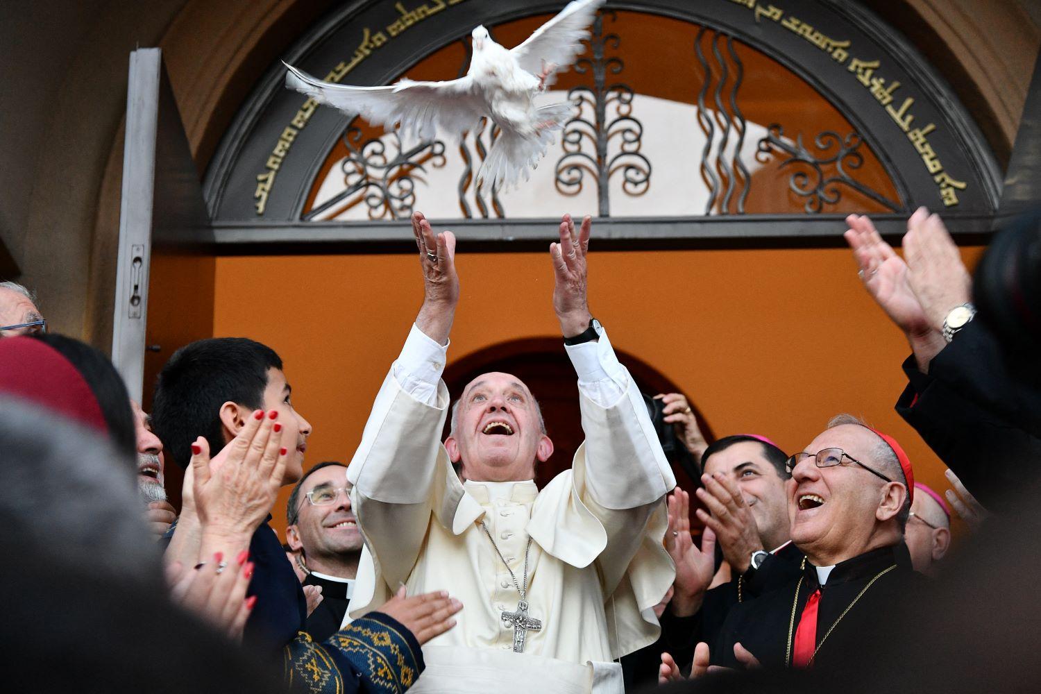 Pope Francis releases a dove as a symbol of peace during a meeting with Chaldean community at the Catholic Church of St Simon Bar Sabbae in Tbilisi. Photo: AFP