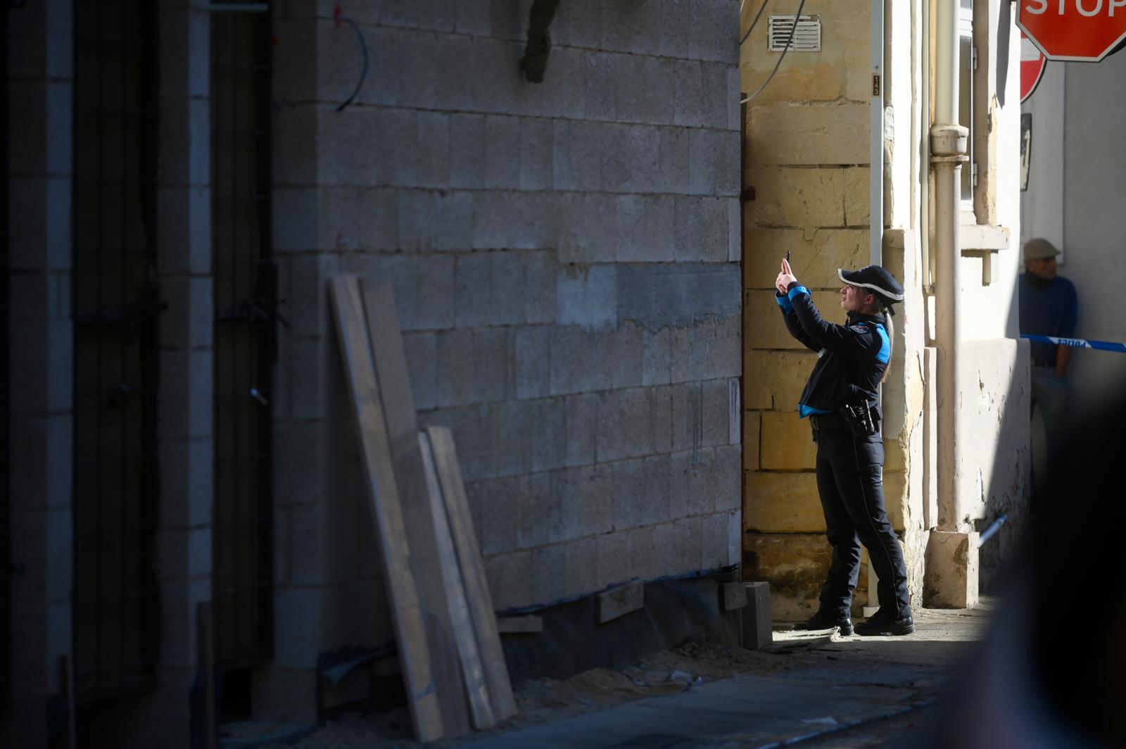 A police officer takes pictures on site in Sta Venera. Photo: Jonathan Borg