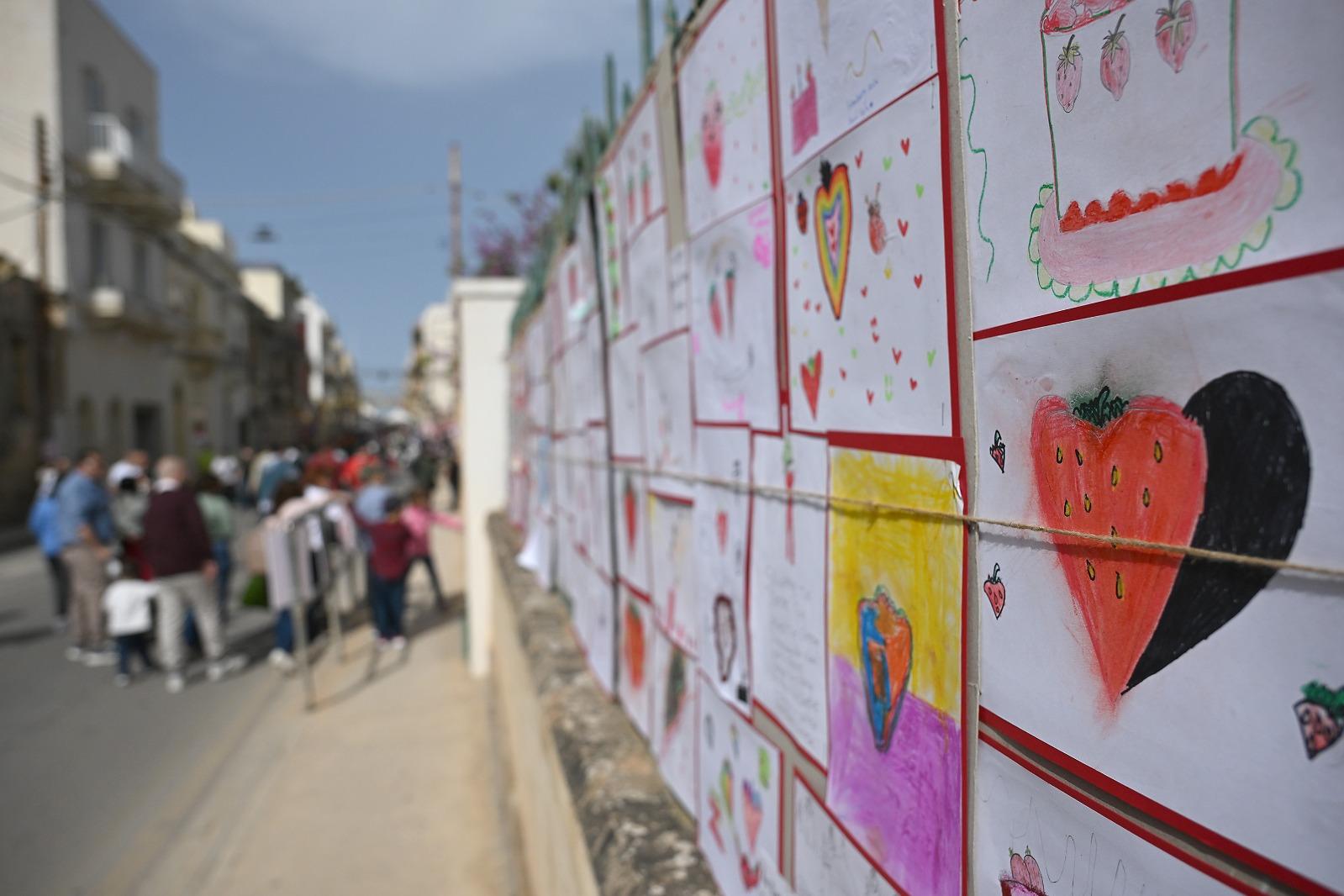 Pictures of strawberries hand-drawn by schoolchildren lined the streets. Photo: Matthew Mirabelli.