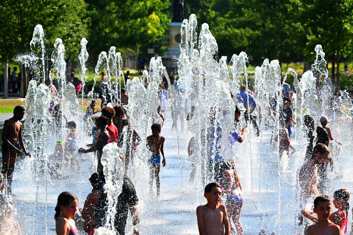 Children refresh themselves at a fountain in Reims, northern France.