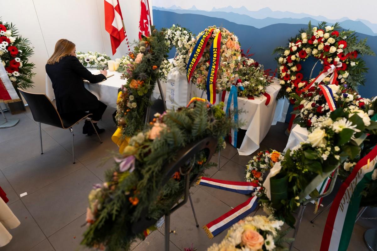 European Parliament president Roberta Metsola signing the book of condolences before the tribute ceremony in Martigny. Photo: AFP
