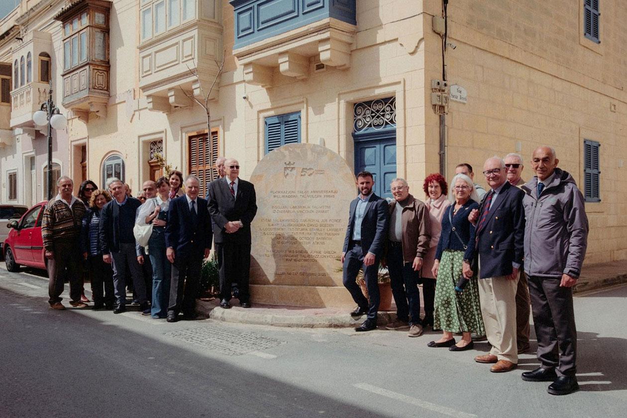 Alcock, along with former friends, colleagues and their families, were welcomed in Żabbar by mayor Jorge Grech and parish priest Roderick Camilleri. Here they are seen standing by the monument erected last year in memory of the crash victims. Photo: Andre