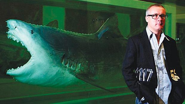 Damien Hirst in front of his shark suspended in formaldehyde titled The Physical Impossibility of Death in the Mind of Someone Living.