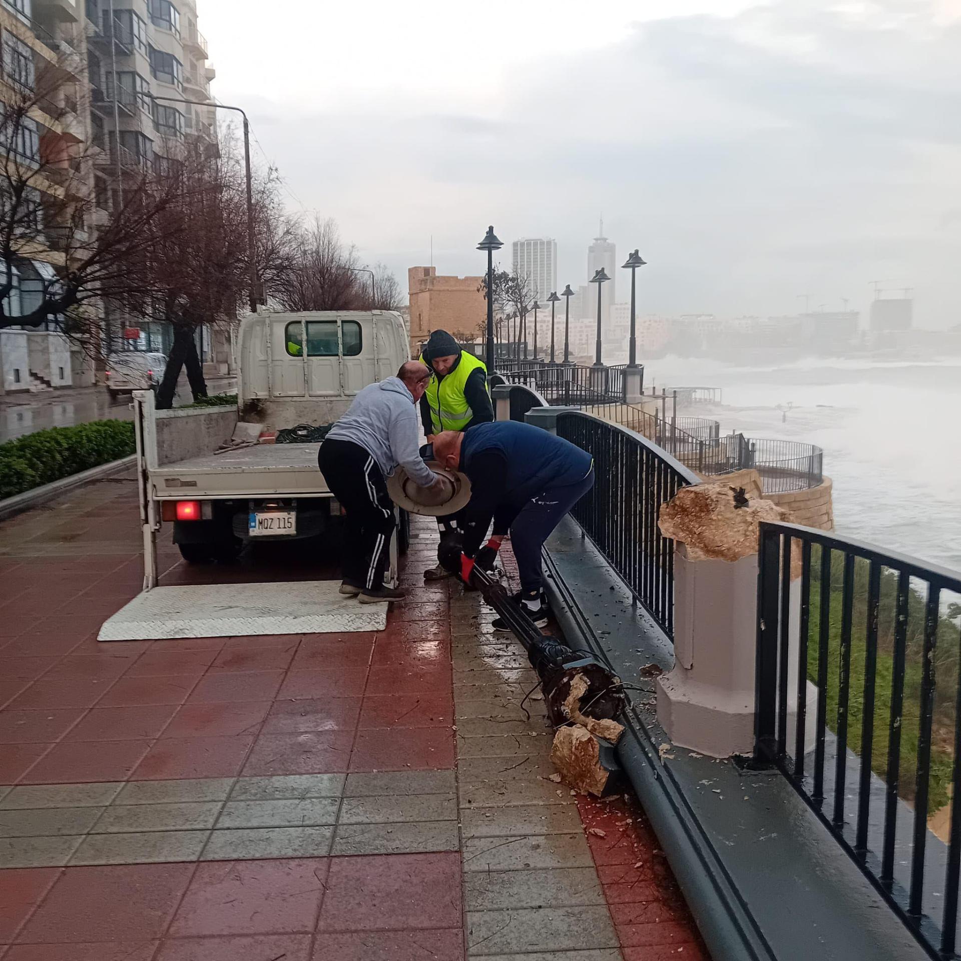 Members of the Tourism Zones Regeneration Agency removed a broken lamp post on Sliema front which was destroyed due to the strong winds and waves. Photo: Facebook/Tourism Zones Regeneration Agency