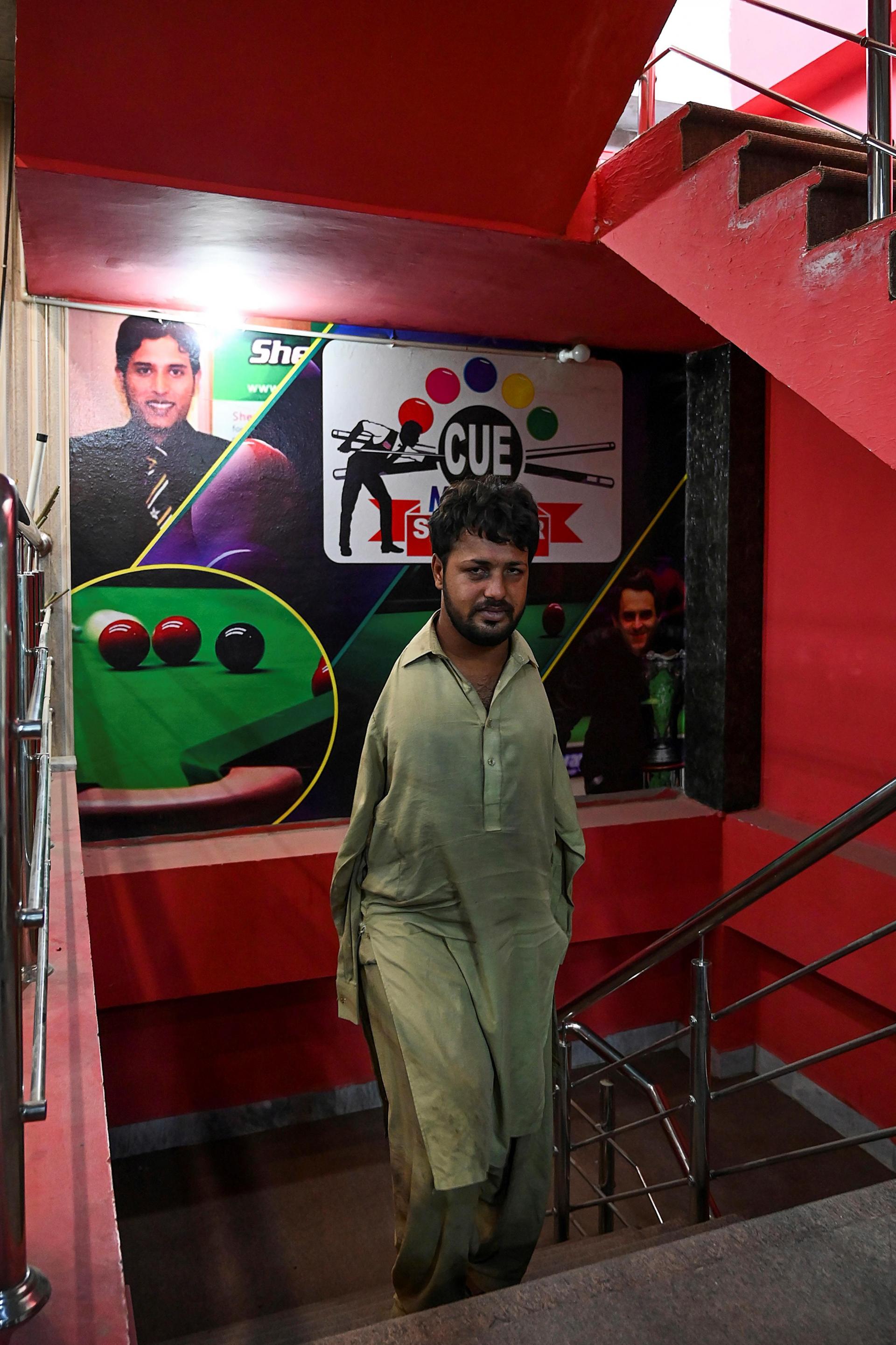 Muhammad Ikram arrives at a local snooker club in Samundri. Photo: AFP
