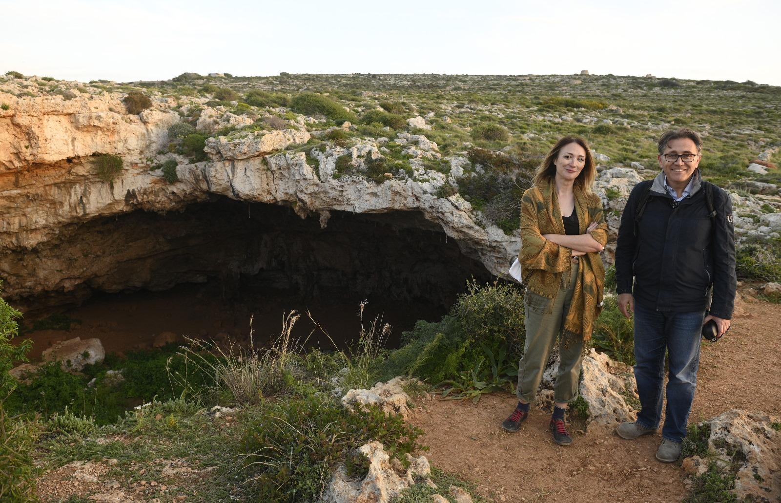 The researchers standing next to the cave where they made history. Photo: Matthew Mirabelli