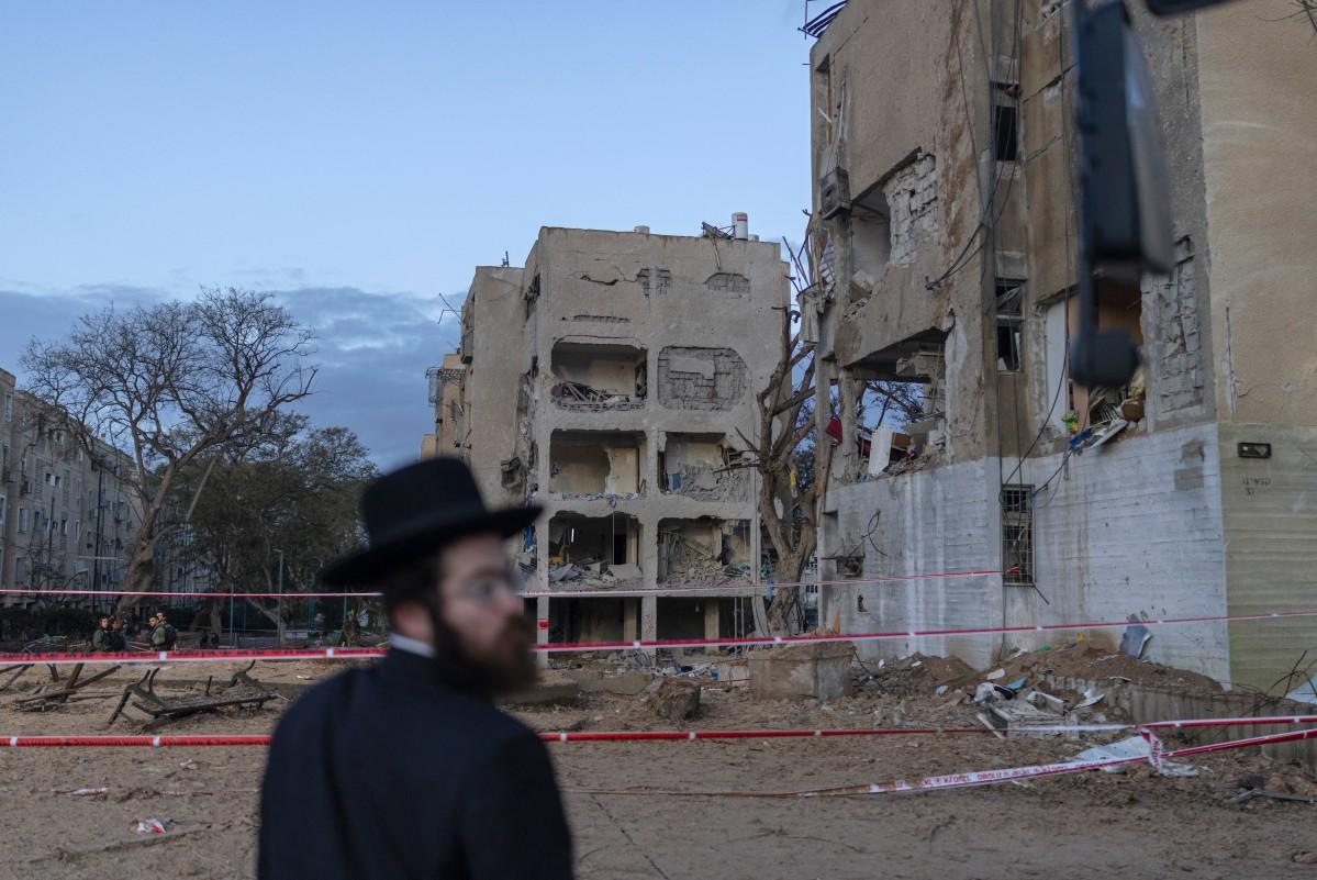 An Israeli Orthodox Jew inspects the site of an Iranian missile strike in Arad, Israel. AFP