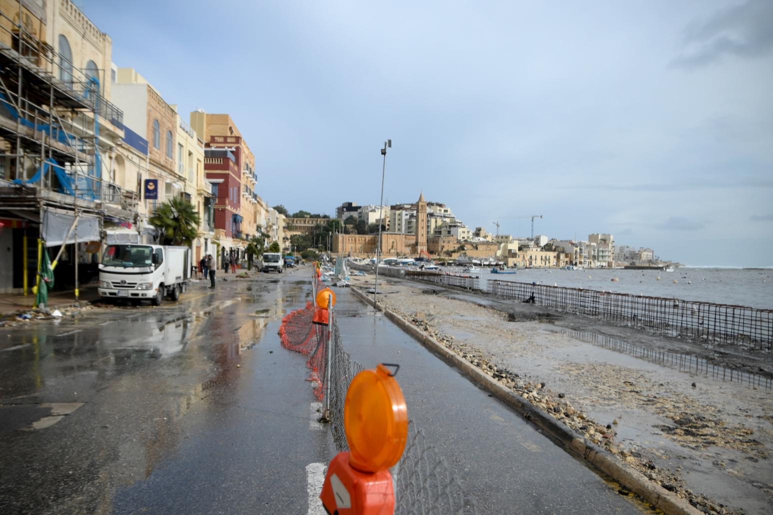 Waves crashed into the road from missing sections of the seawall. (Jonathan Borg)