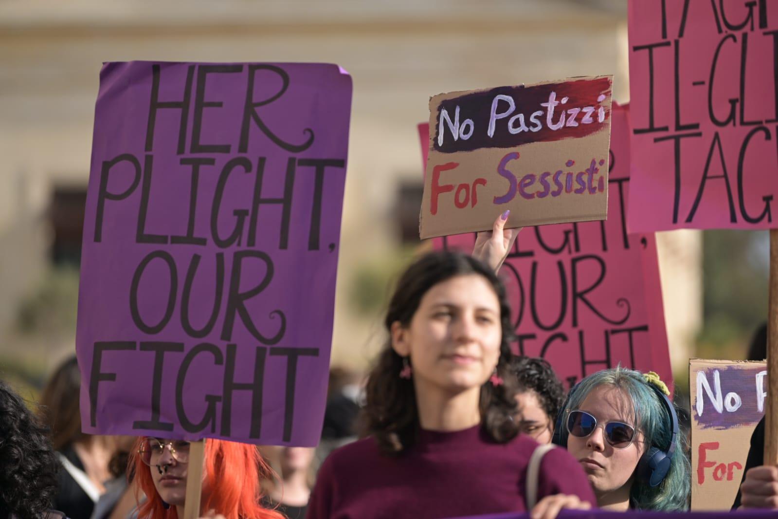 Activists carried different posters for the International Women's Day march. Photo: Matthew Mirabelli
