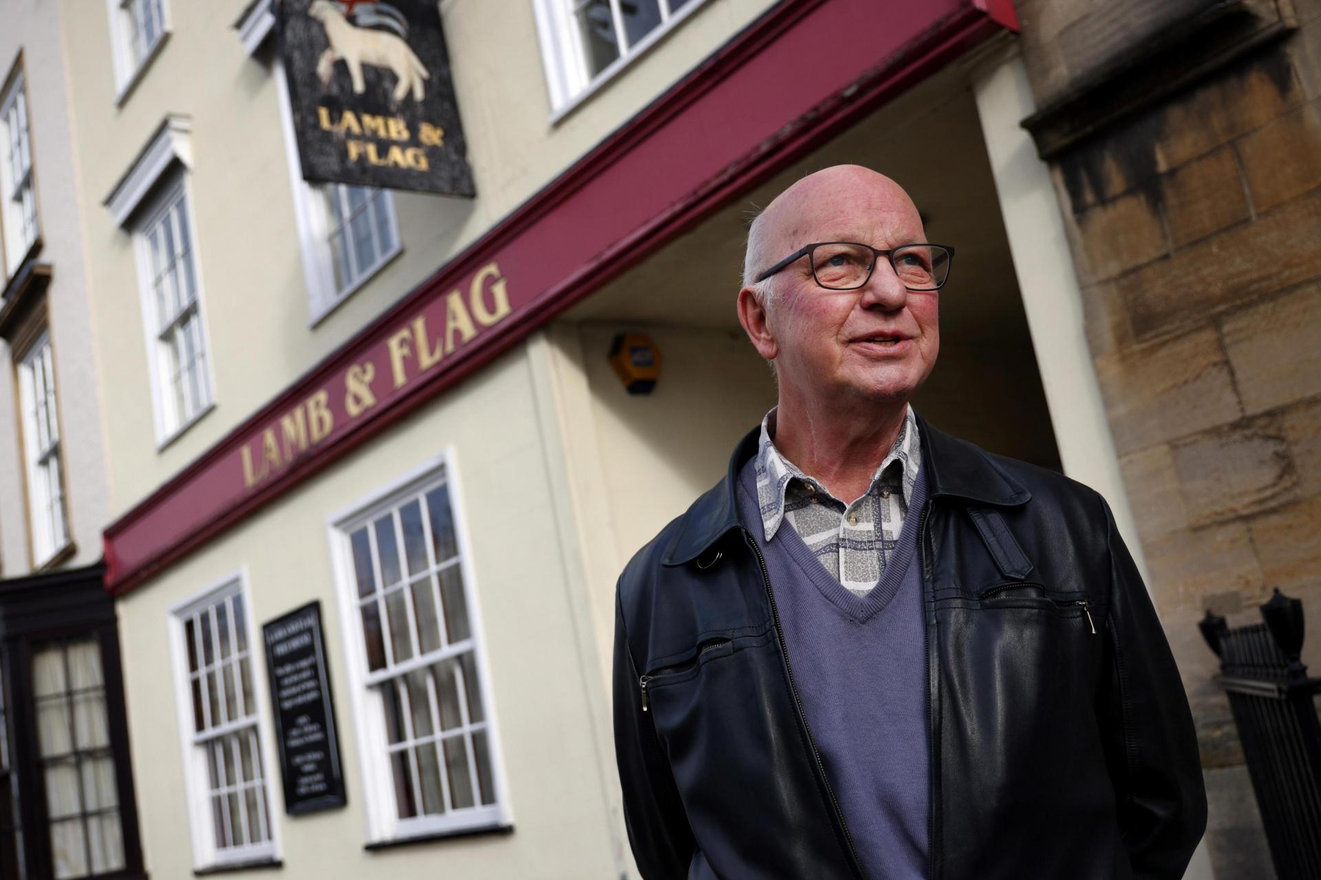 Dave Richardson, Oxford's Campaign for Real Ale (CAMRA) spokesperson, poses for a photograph outside the closed-down Lamb and Flag pub.