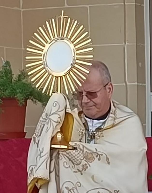 Bishop George Bugeja OFM (right) imparting a Holy Eucharist blessing upon Mġarr harbour. Photos: Charles Spiteri